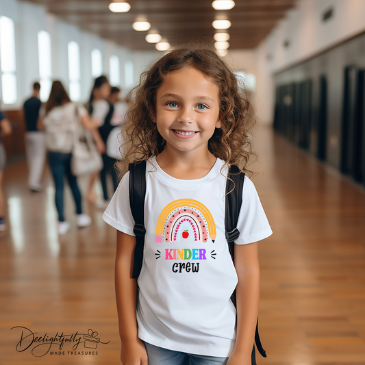 Girl wearing white Bella + Canvas crewneck t-shirt with a rainbow kinder crew design.