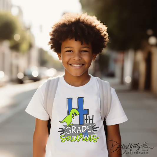 Boy wearing a white crewneck Bella + Canvas youth shirt with a fourth grade dinosaur design.
